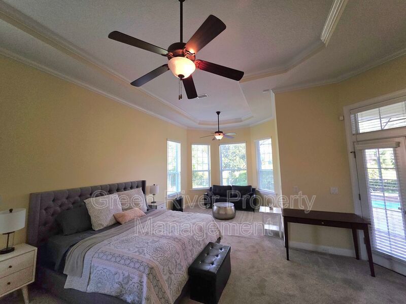 Spacious 5BR/5BA Home with Screened Pool & Pond View in Eagle Harbor at Black Creek! property image