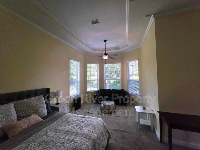 Spacious 5BR/5BA Home with Screened Pool & Pond View in Eagle Harbor at Black Creek! property image