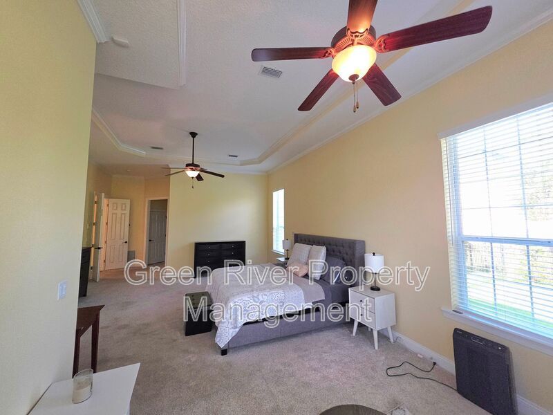 Spacious 5BR/5BA Home with Screened Pool & Pond View in Eagle Harbor at Black Creek! property image
