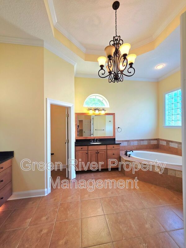 Spacious 5BR/5BA Home with Screened Pool & Pond View in Eagle Harbor at Black Creek! property image